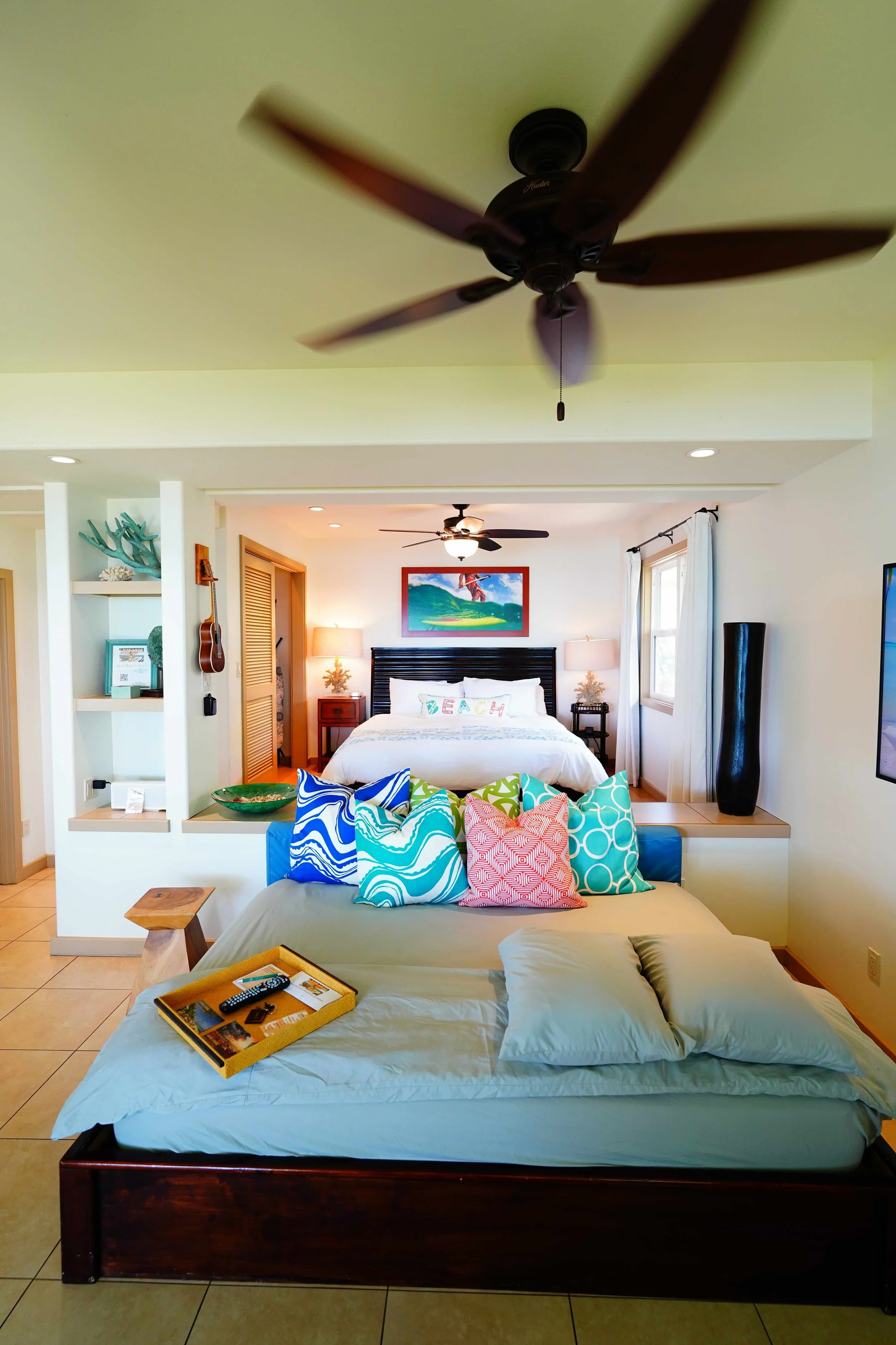 Cottage interior with king bed and beach-themed decor