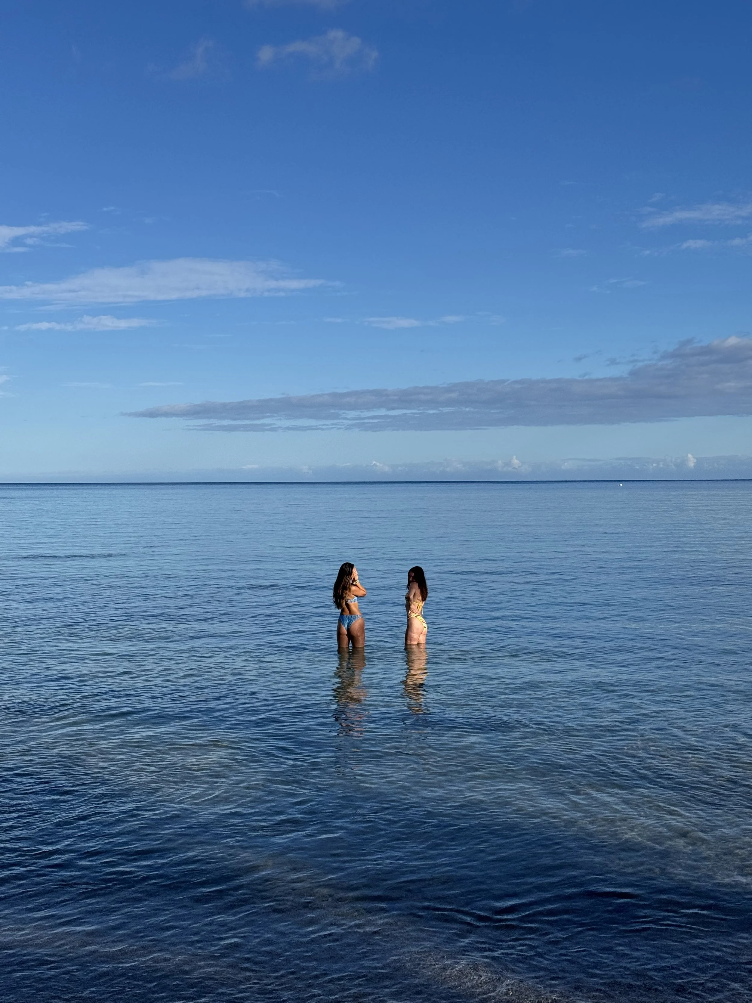 Two guests swimming in the calm water of Anaeho'omalu Bay