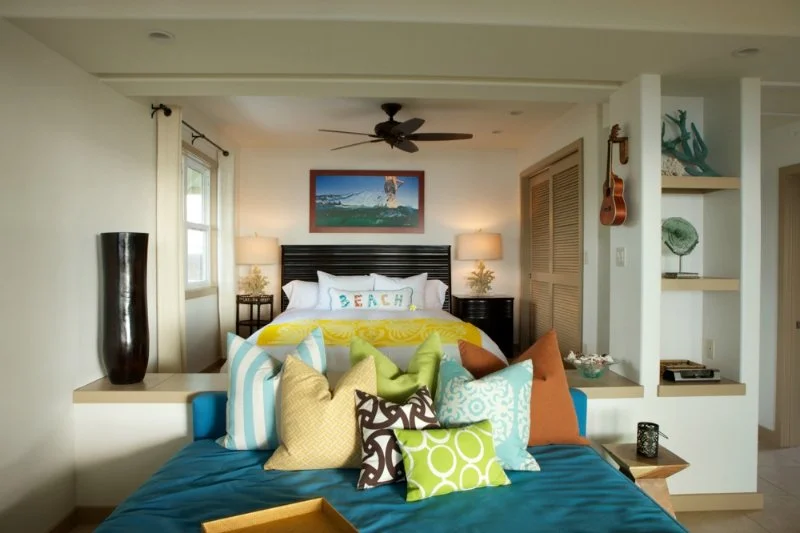 Punee day bed area with colorful pillows and coastal art